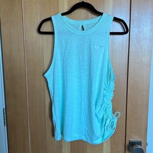 Nike open back tank top with draw string ruching on one side.